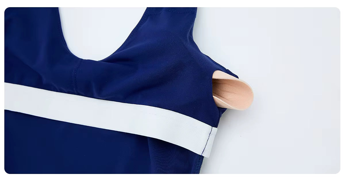 Navy blue top with a white stripe on a light gray background